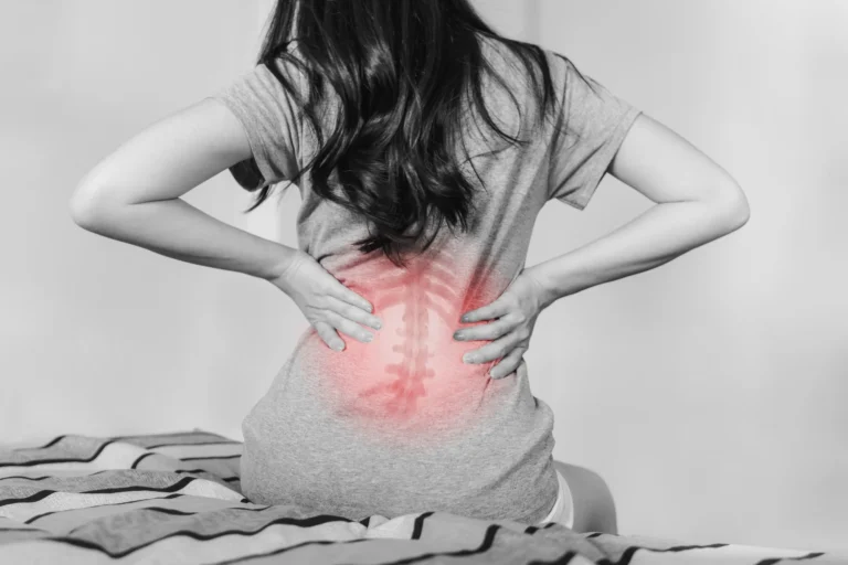 Woman with lower back scoliosis pain